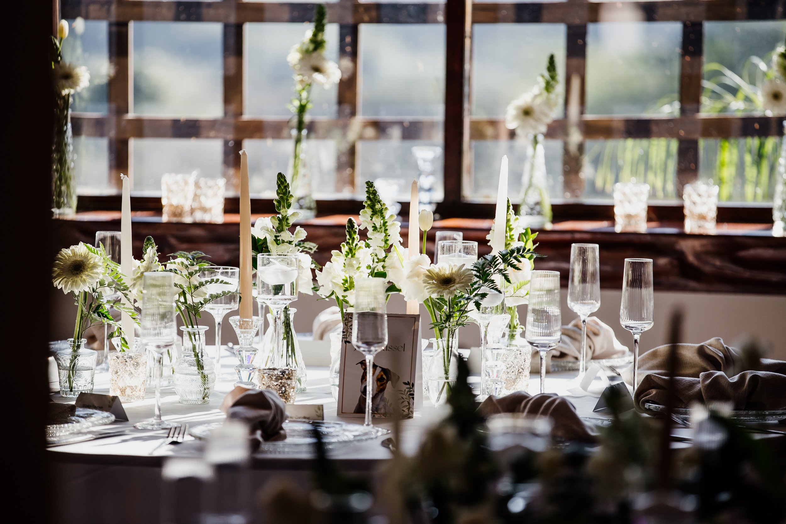A refined white floral wedding table styled by Elizabeth May Events